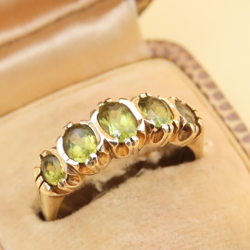 87 - Peridot Five Stone Ring Mounted on 9 Carat Yellow Gold Band Ring Size Q