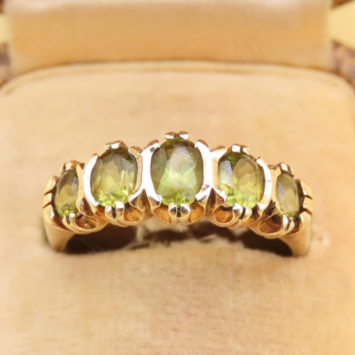 87 - Peridot Five Stone Ring Mounted on 9 Carat Yellow Gold Band Ring Size Q