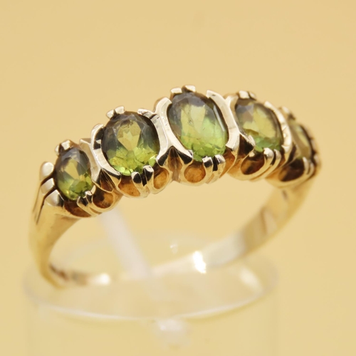 87 - Peridot Five Stone Ring Mounted on 9 Carat Yellow Gold Band Ring Size Q