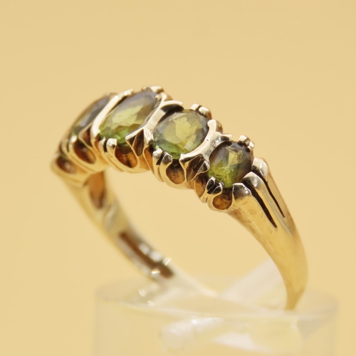 87 - Peridot Five Stone Ring Mounted on 9 Carat Yellow Gold Band Ring Size Q