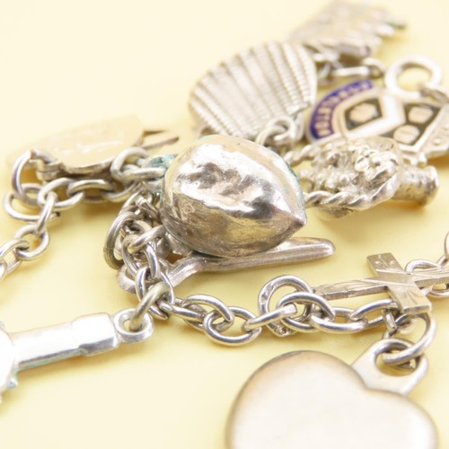 1044 - Silver Charm Bracelet Laden with Various Charms Including Crucifix, Love Heart, Floral Basket, etc 1... 