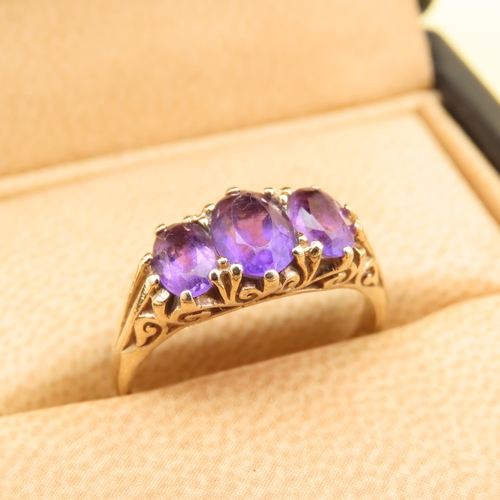 102 - Three Stone Amethyst Ring Mounted on 9 Carat Yellow Gold Band Size O