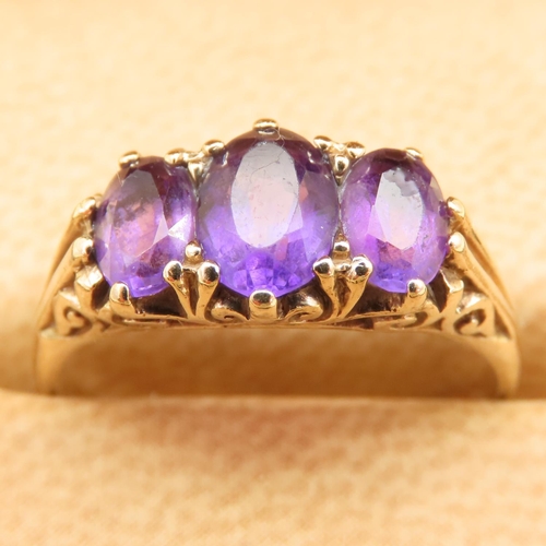 102 - Three Stone Amethyst Ring Mounted on 9 Carat Yellow Gold Band Size O