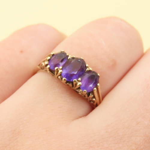 102 - Three Stone Amethyst Ring Mounted on 9 Carat Yellow Gold Band Size O