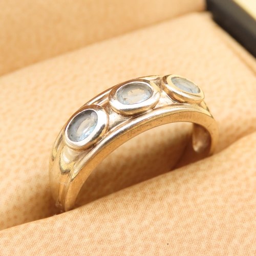 131 - Three Stone Aquamarine Ring Mounted on a 9 Carat Yellow Gold Band Size M