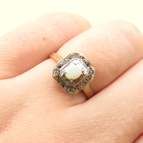 144 - Opal and Diamond Halo Ring Mounted on 9 Carat Yellow Gold Band Size N and a Half