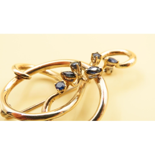 168 - 18 Carat Yellow Gold Six Stone Sapphire Set Ladies Brooch Shaped Form 5cm Wide x 4cm High