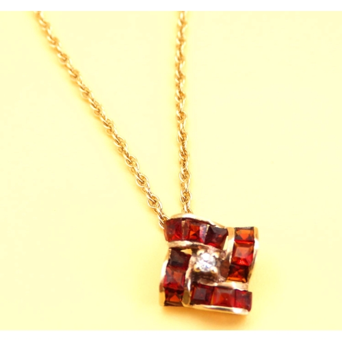 19 - Garnet and Diamond Pedant 1cm Square Set in 9 Carat Gold further Mounted on 9 Carat Yellow Gold Chai... 