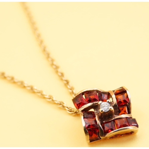 19 - Garnet and Diamond Pedant 1cm Square Set in 9 Carat Gold further Mounted on 9 Carat Yellow Gold Chai... 