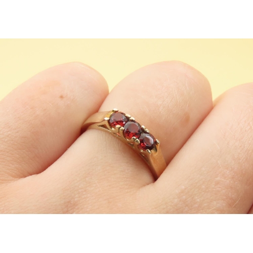 254 - Mozambique Garnet Three Stone Ring Mounted on a 9 Carat Yellow Gold Band Size N