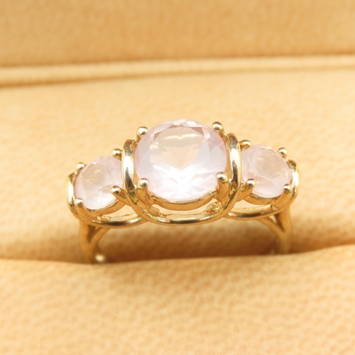 255 - Three Stone Rose Quartz Ring Mounted on 9 Carat Yellow Gold Band Size N