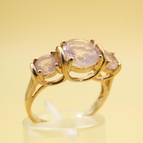 255 - Three Stone Rose Quartz Ring Mounted on 9 Carat Yellow Gold Band Size N