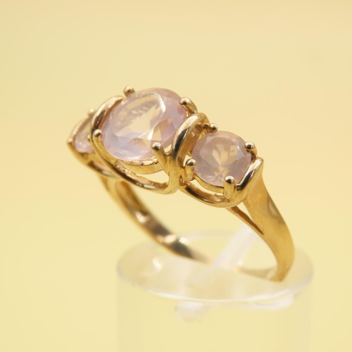 255 - Three Stone Rose Quartz Ring Mounted on 9 Carat Yellow Gold Band Size N