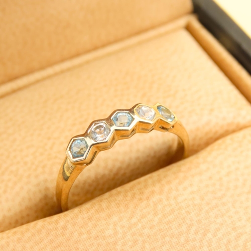 264 - Swiss Blue and White Topaz Set Five Stone Ring Mounted on a 9 Carat Yellow Gold Band Size N