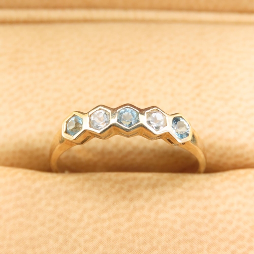 264 - Swiss Blue and White Topaz Set Five Stone Ring Mounted on a 9 Carat Yellow Gold Band Size N