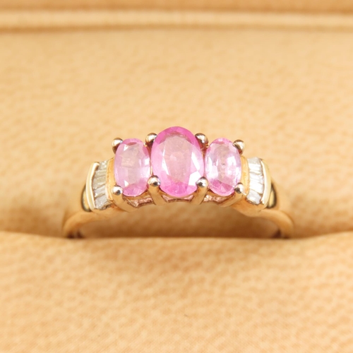 289 - Three Stone Pink Garnet Ring Further Set with Diamonds to Shoulders Mounted on 9 Carat Yellow Gold B... 