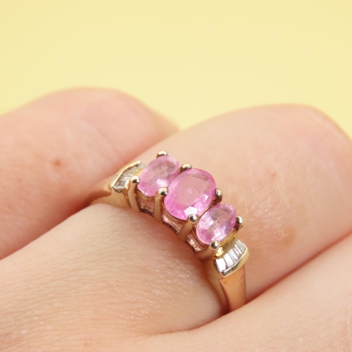 289 - Three Stone Pink Garnet Ring Further Set with Diamonds to Shoulders Mounted on 9 Carat Yellow Gold B... 