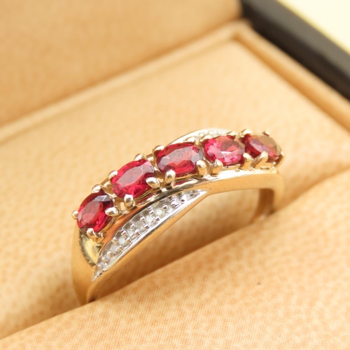 303 - Red Garnet and Diamond Set Cross Over Design Ring Mounted on 10 Carat Yellow Gold Band Size P and a ... 