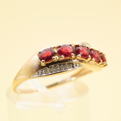 303 - Red Garnet and Diamond Set Cross Over Design Ring Mounted on 10 Carat Yellow Gold Band Size P and a ... 