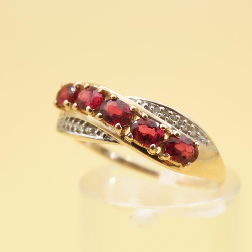 303 - Red Garnet and Diamond Set Cross Over Design Ring Mounted on 10 Carat Yellow Gold Band Size P and a ... 