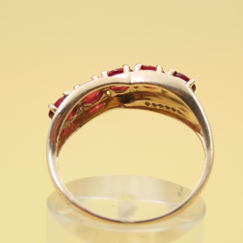 303 - Red Garnet and Diamond Set Cross Over Design Ring Mounted on 10 Carat Yellow Gold Band Size P and a ... 