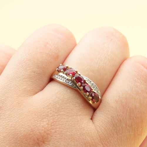 303 - Red Garnet and Diamond Set Cross Over Design Ring Mounted on 10 Carat Yellow Gold Band Size P and a ... 