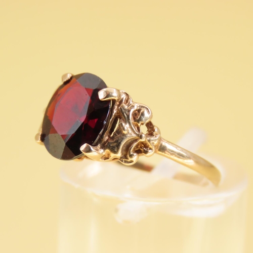 309 - Red Garnet Centerstone Ring Four Claw Set Mounted on 9 Carat Yellow Gold Band Size L