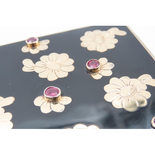 321 - Van Cleef & Arpels RUBY AND ENAMEL 'BAGATELLE' MINAUDIARE 
Black Enamel with Circular Cut Rubies 18K... 