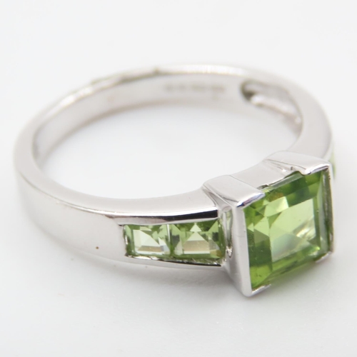 329 - Princess Cut Peridot Center Stone Ring with Further Peridot set to Shoulders Mounted on 9 Carat Whit... 