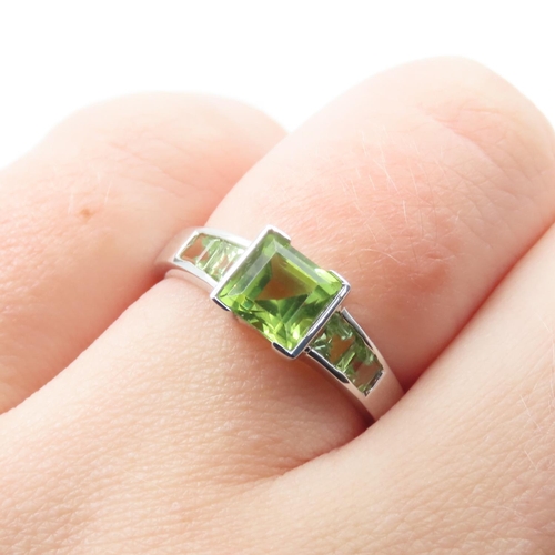 329 - Princess Cut Peridot Center Stone Ring with Further Peridot set to Shoulders Mounted on 9 Carat Whit... 