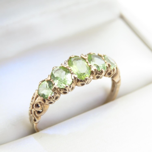 336 - Five Stone Peridot Ladies Ring Mounted on 9 Carat Yellow Gold Band Ring Size T