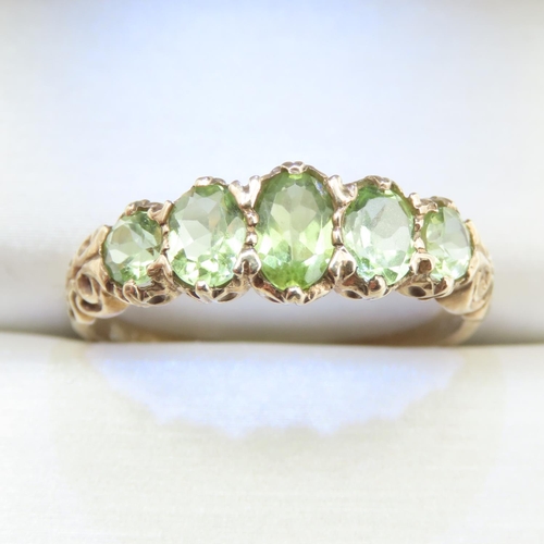 336 - Five Stone Peridot Ladies Ring Mounted on 9 Carat Yellow Gold Band Ring Size T