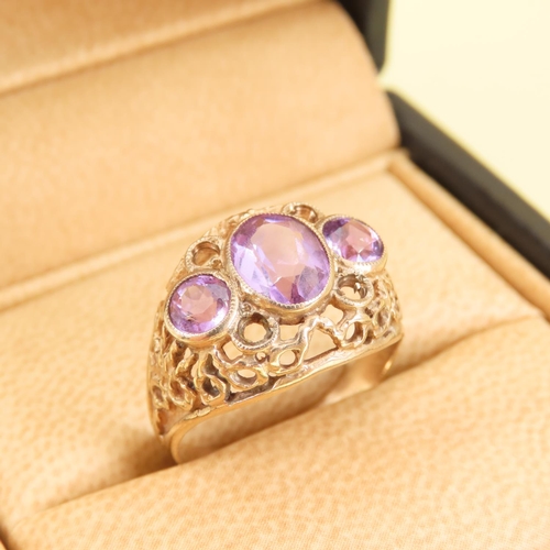 346 - Three Stone Amethyst Ladies Ring Mounted on 9 Carat Yellow Gold Openwork Scroll Setting Ring Size O