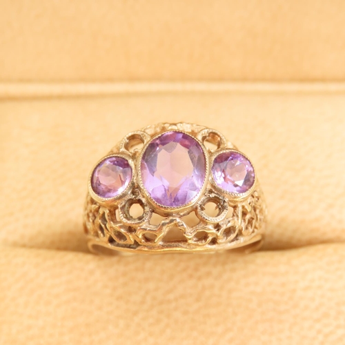 346 - Three Stone Amethyst Ladies Ring Mounted on 9 Carat Yellow Gold Openwork Scroll Setting Ring Size O