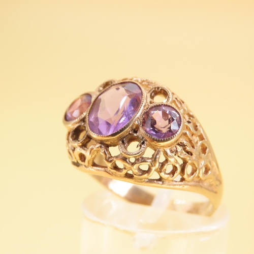 346 - Three Stone Amethyst Ladies Ring Mounted on 9 Carat Yellow Gold Openwork Scroll Setting Ring Size O