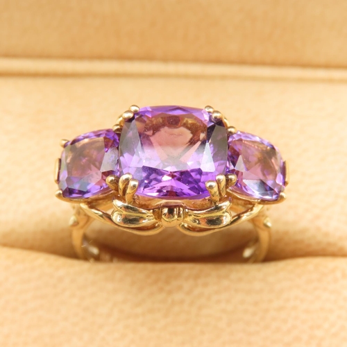 414 - Amethyst Three Stone Ring of Fine Hue Mounted on 9 Carat Yellow Gold Band Size P