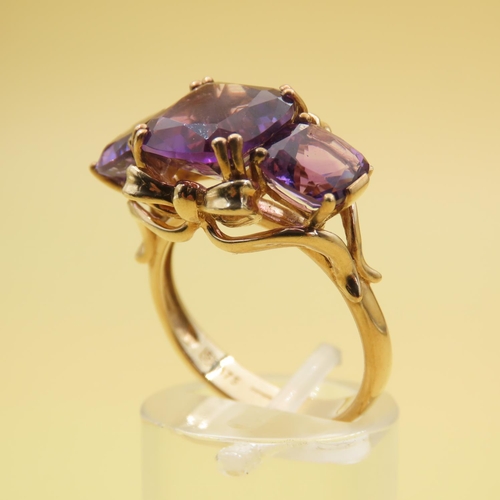 414 - Amethyst Three Stone Ring of Fine Hue Mounted on 9 Carat Yellow Gold Band Size P