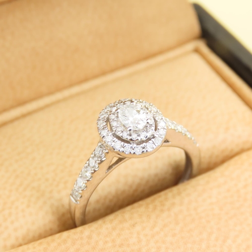 438 - 18 Carat White Gold Diamond Solitaire Ring Halo Set with Further Diamond Decorated Shoulders Attract... 