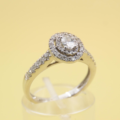 438 - 18 Carat White Gold Diamond Solitaire Ring Halo Set with Further Diamond Decorated Shoulders Attract... 