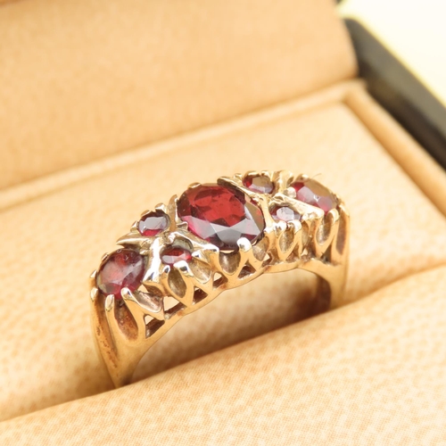 557 - Seven Stone Red Garnet Ring Mounted on 9 Carat Yellow Gold Band Size L