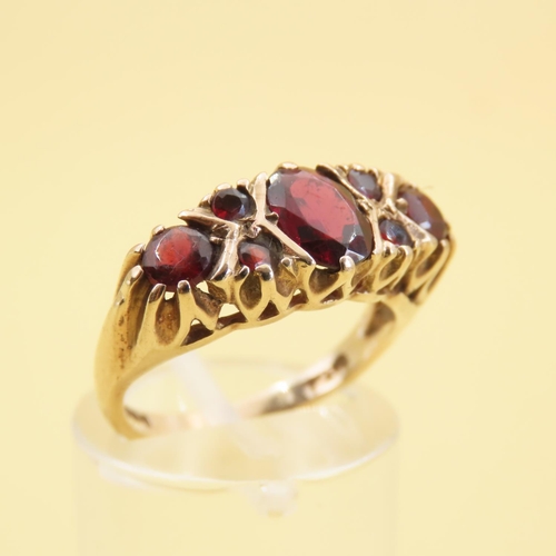 557 - Seven Stone Red Garnet Ring Mounted on 9 Carat Yellow Gold Band Size L