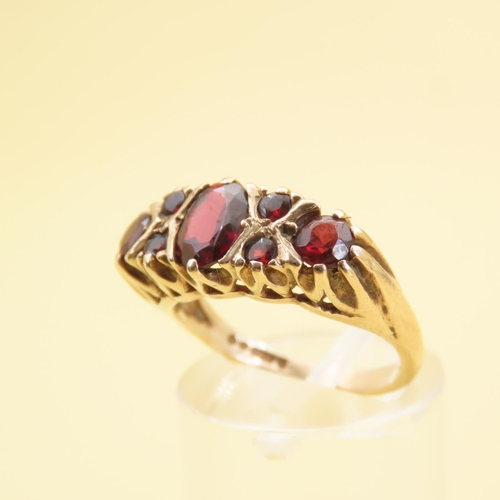 557 - Seven Stone Red Garnet Ring Mounted on 9 Carat Yellow Gold Band Size L