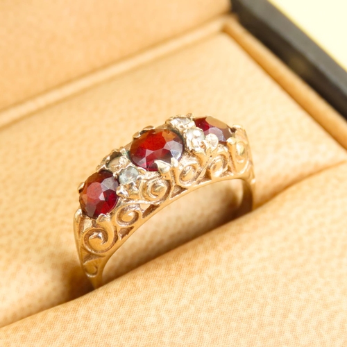 570 - Three Stone Red Garnet and Gemstone Ring Mounted on 9 Carat Yellow Gold Band Size L