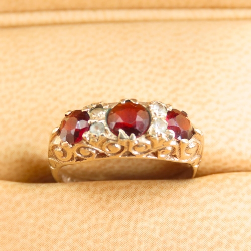 570 - Three Stone Red Garnet and Gemstone Ring Mounted on 9 Carat Yellow Gold Band Size L