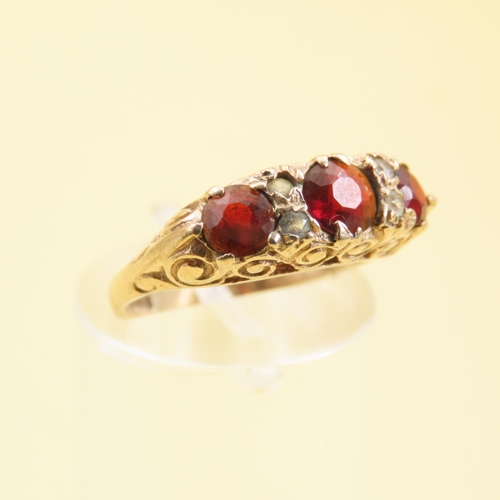 570 - Three Stone Red Garnet and Gemstone Ring Mounted on 9 Carat Yellow Gold Band Size L