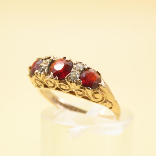 570 - Three Stone Red Garnet and Gemstone Ring Mounted on 9 Carat Yellow Gold Band Size L