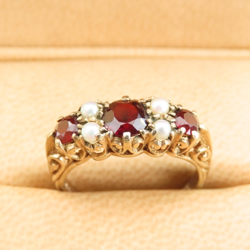 575 - Three Stone Red Garnet and Seed Pearl Ring Mounted on 9 Carat Yellow Gold Band Size P