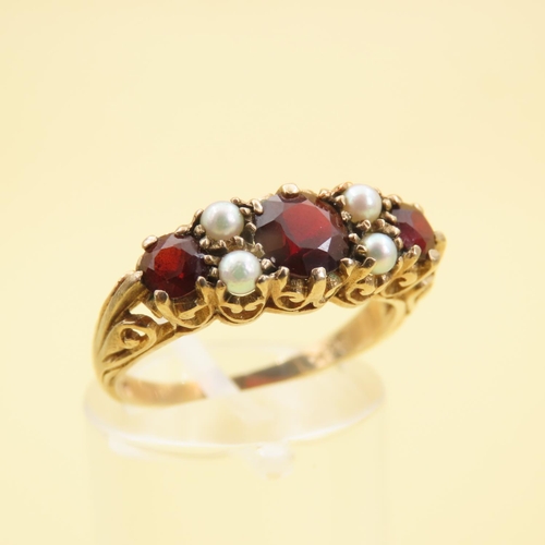 575 - Three Stone Red Garnet and Seed Pearl Ring Mounted on 9 Carat Yellow Gold Band Size P