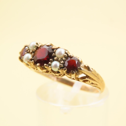 575 - Three Stone Red Garnet and Seed Pearl Ring Mounted on 9 Carat Yellow Gold Band Size P