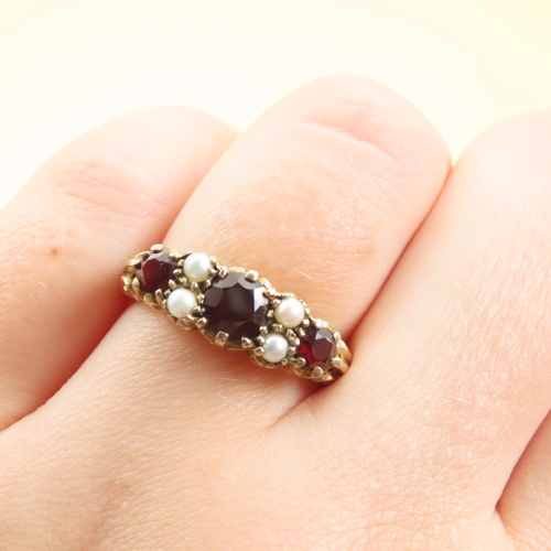 575 - Three Stone Red Garnet and Seed Pearl Ring Mounted on 9 Carat Yellow Gold Band Size P